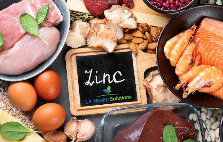 Benefits of Zinc - Image of word (ZINC with La Health Solutions Logo) and Food background