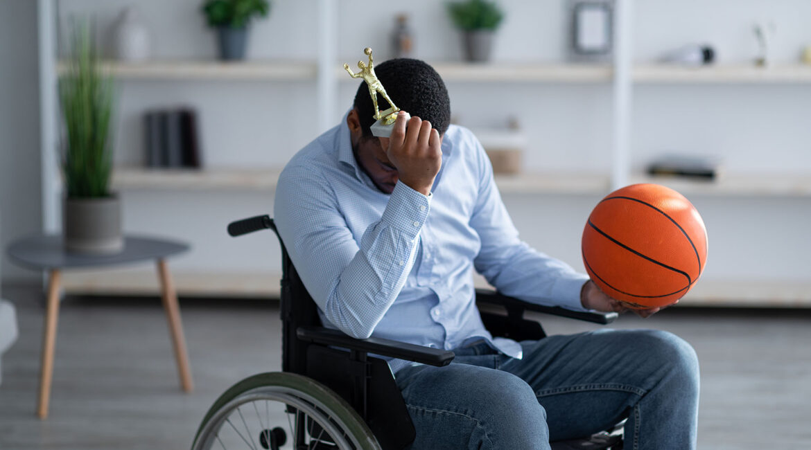 Stress and Healing, an athlete in pain siting in wheelchair